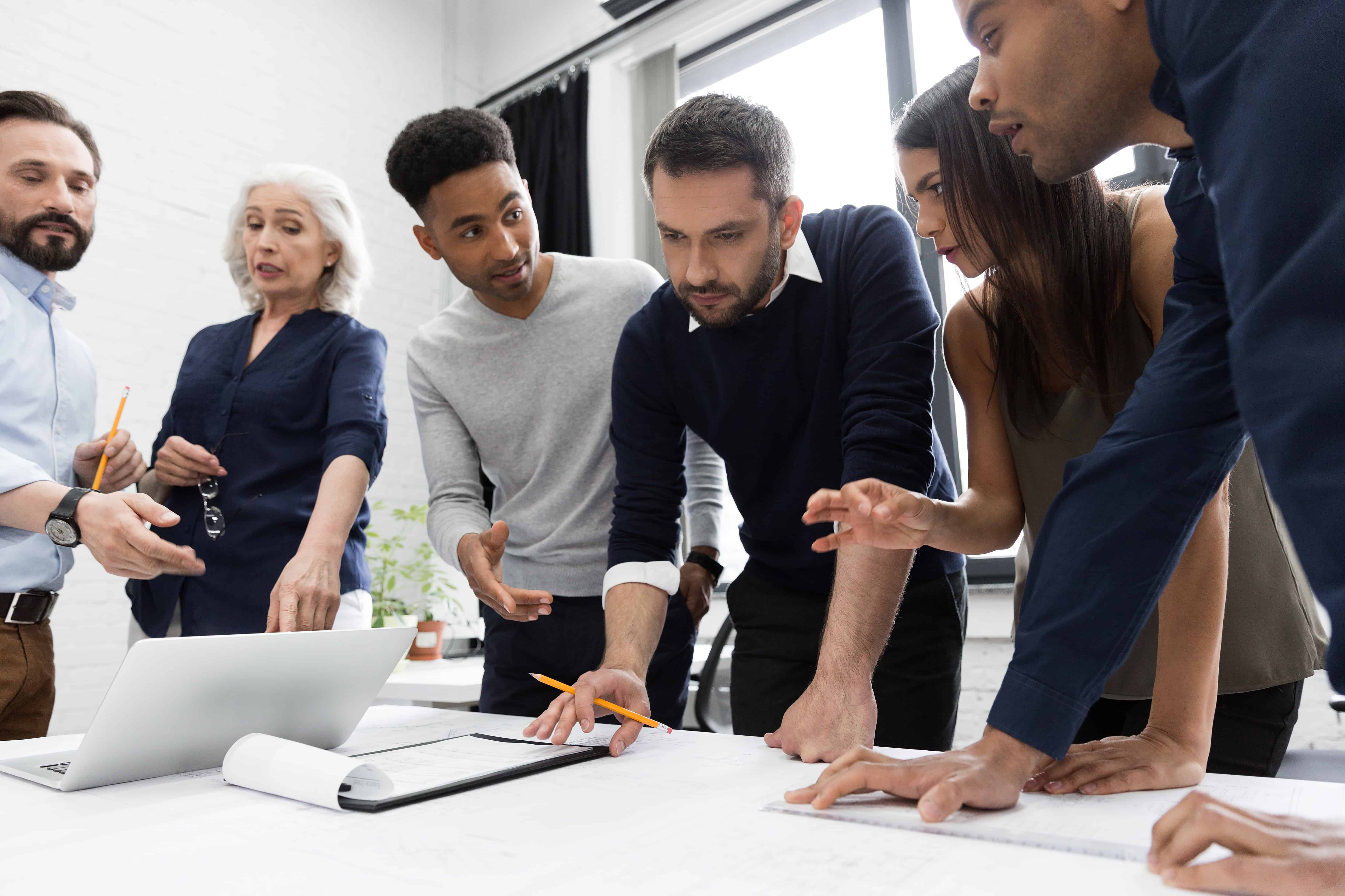 group of businesspeople working at a table in the P5CUCYH september 19th, 2019